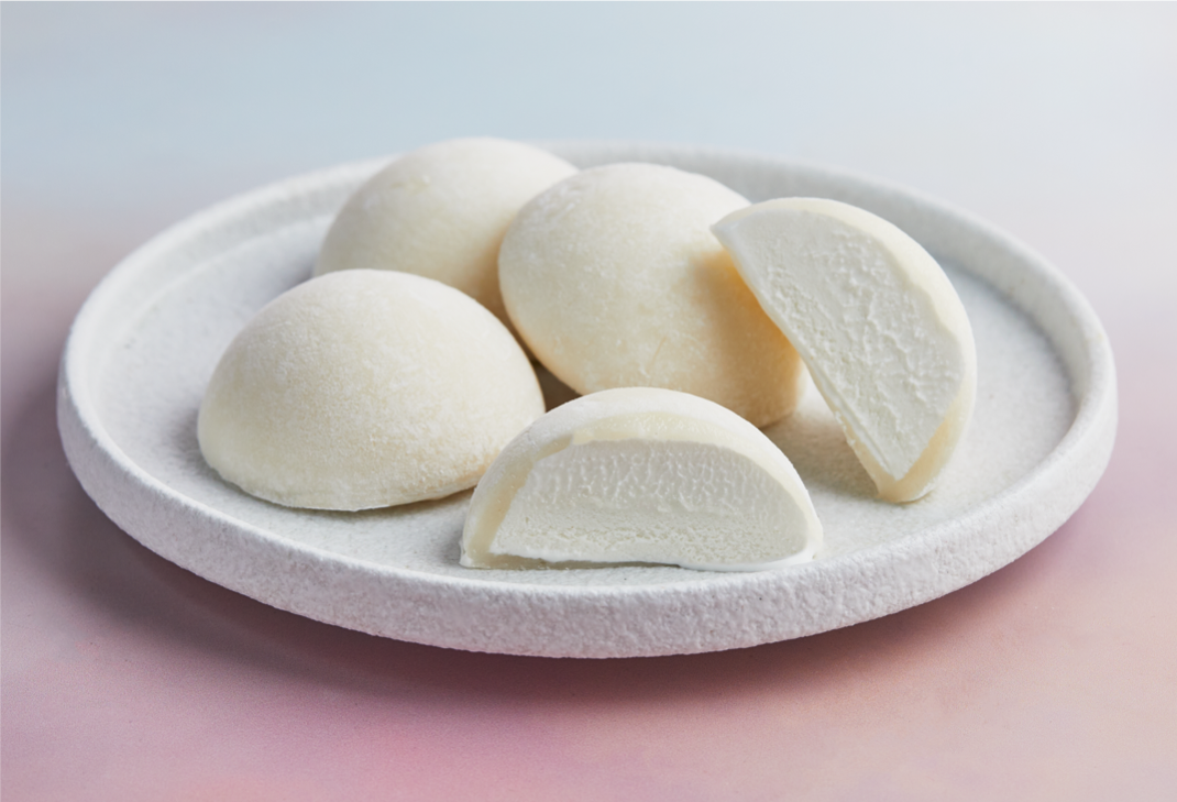 A white plate filled with coconut flavored mochi ice cream from MOISHI Dubai's best mochi ice cream brand.