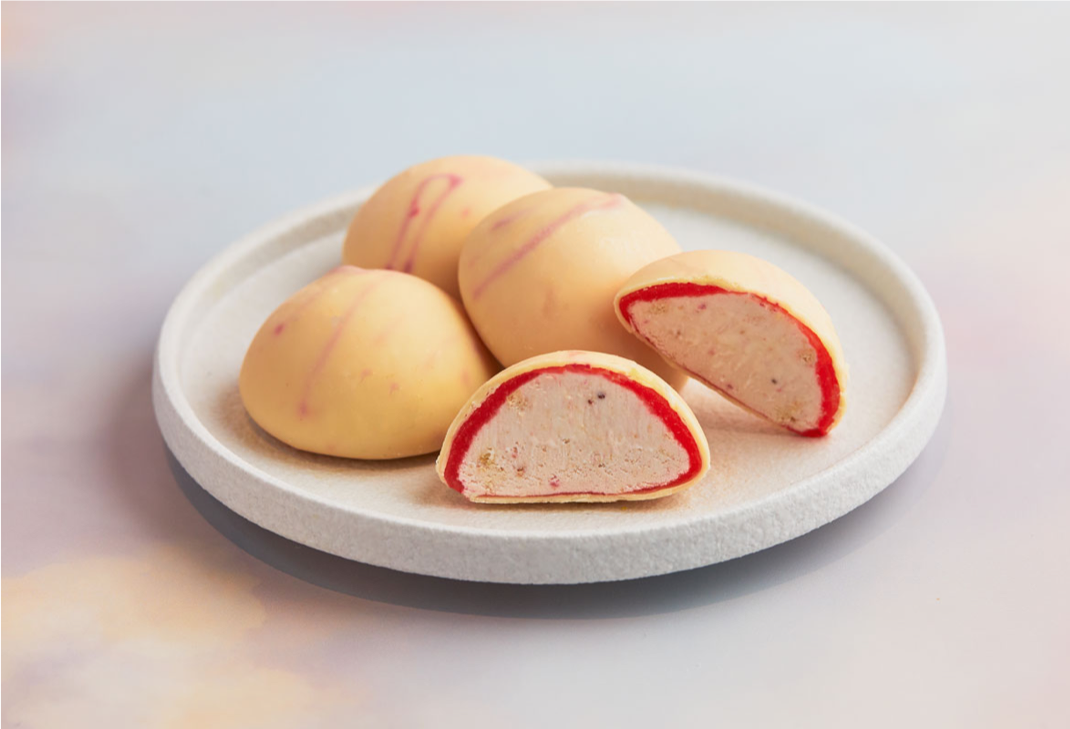 A white colored plate contains four pieces Crunchy Strawberry Cheesecake Mochi Ice Cream - MOISHI