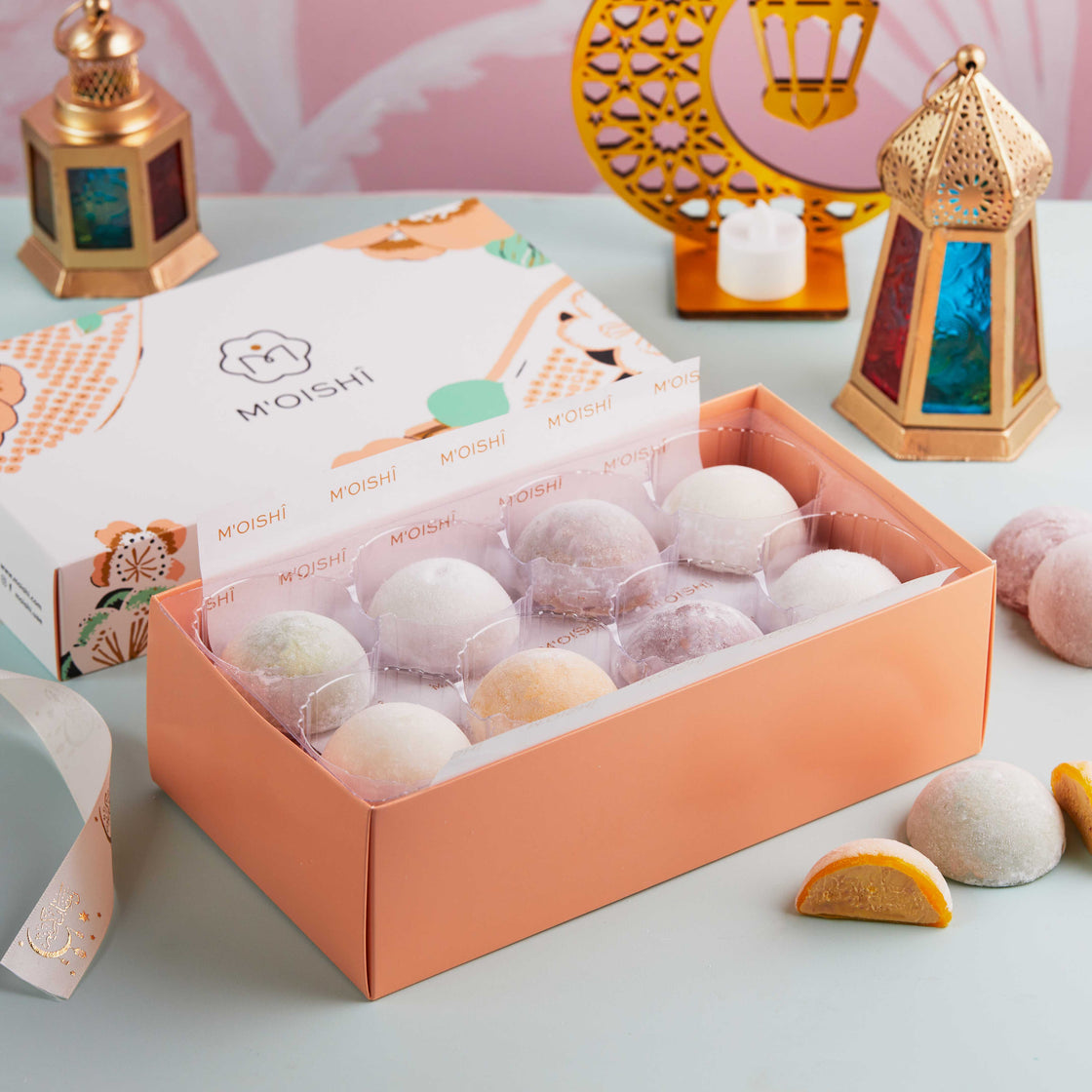 A table topped with MOISHI Ramadan Gift box of 12 Assorted Mochi Ice Cream pieces