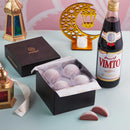 A table topped with a bottle of wine and MOISHI Ramadan Gift box of 8 Vimto Mochi Ice Cream pieces