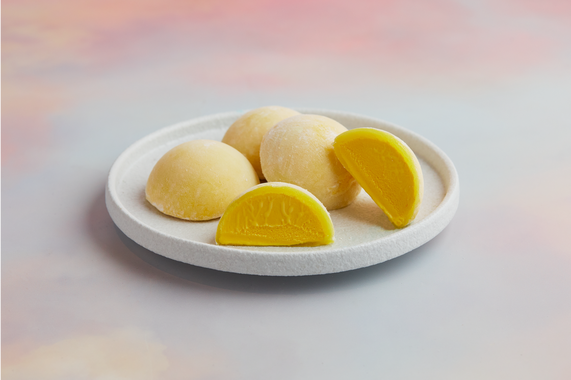 A white plate topped with 4 of pieces MOISHI Saffron flavor mochi ice cream