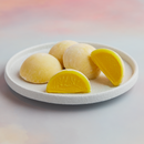 A white plate topped with 4 of pieces MOISHI Saffron flavor mochi ice cream