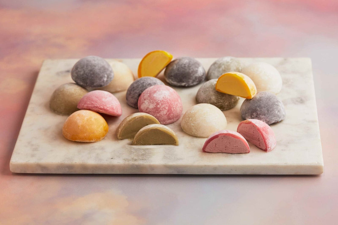 A white plate topped with diverse range of assorted Moishi ice cream of MOISHI a renowned Japanese dessert brand in Dubai.