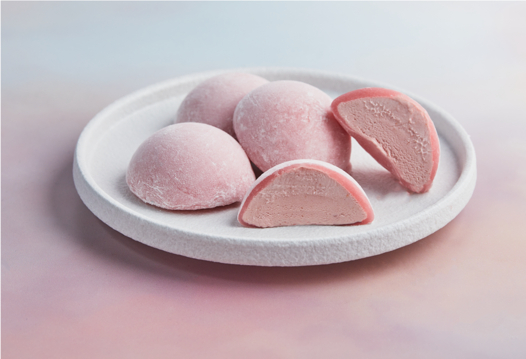 A white plate topped with 4 pieces of Strawberry flavored Moishi Ice Cream of MOISHI, the best mochi ice cream shop in Dubai